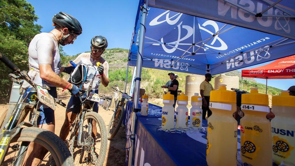 Riders at a nutrition station during the race