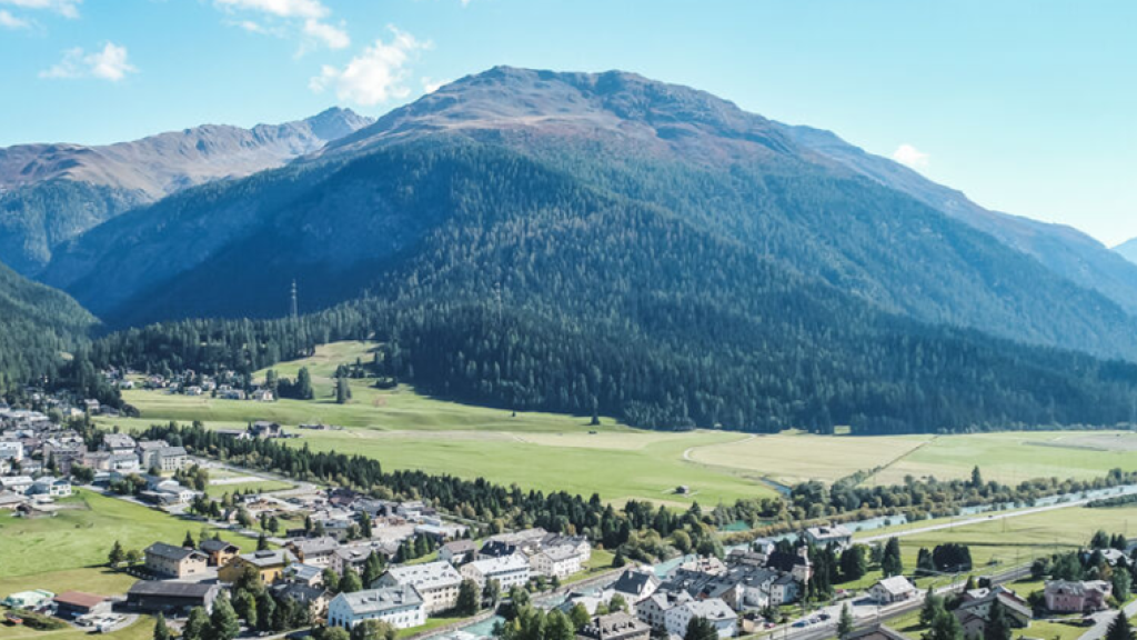 Bird's eye view of a city in Switzerland surrounded by nature and mountains