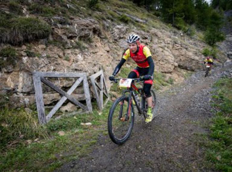 A biker heading down a gravel path