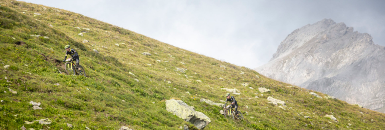 A large hill with bikers on the side of it