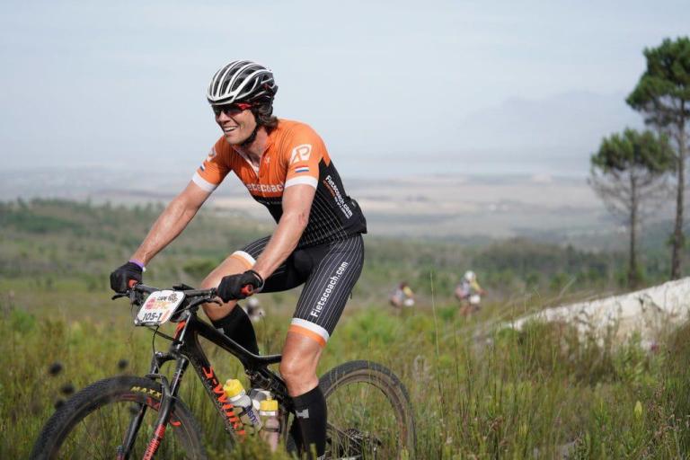 Close up of Enrico Theuns biking in a field
