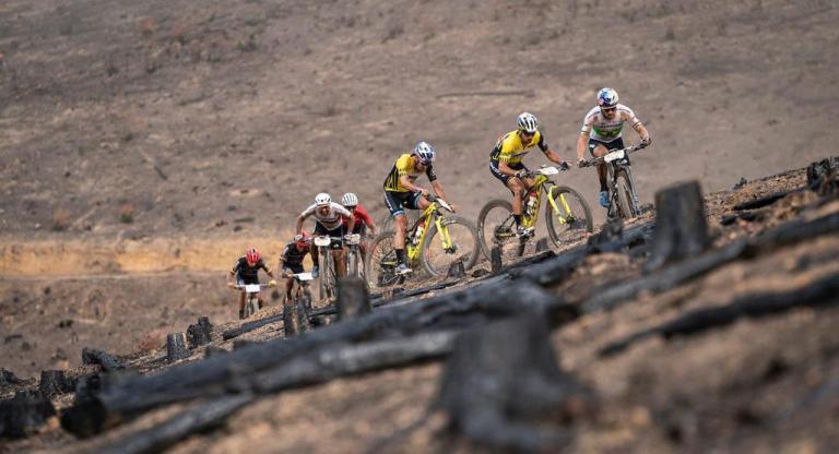multiple bikers heading up an incline
