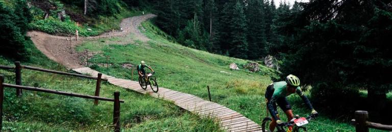 Two bikers heading over the bridge