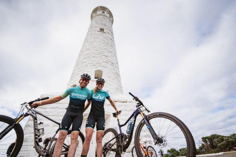 Two bikers posing in front  of Cape Leeuwin Lighthouse