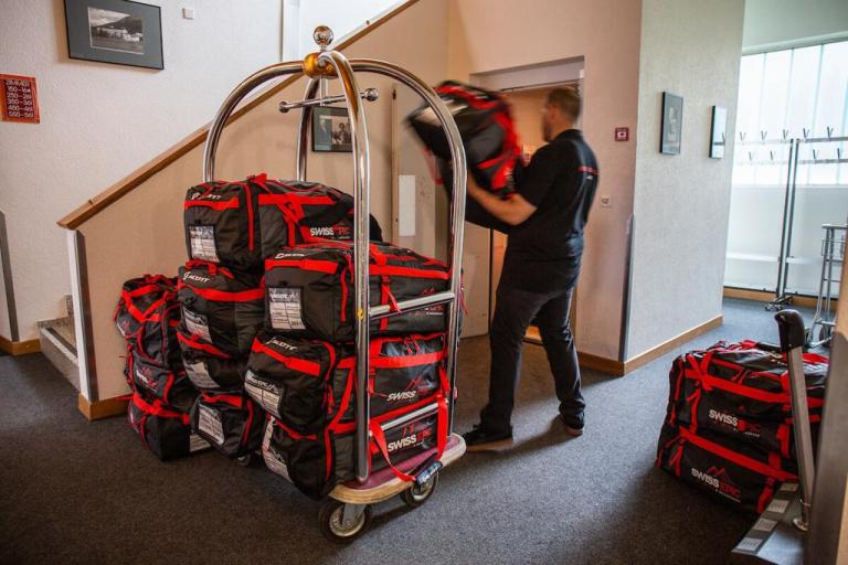 A hotel worker unloading swiss epic bags