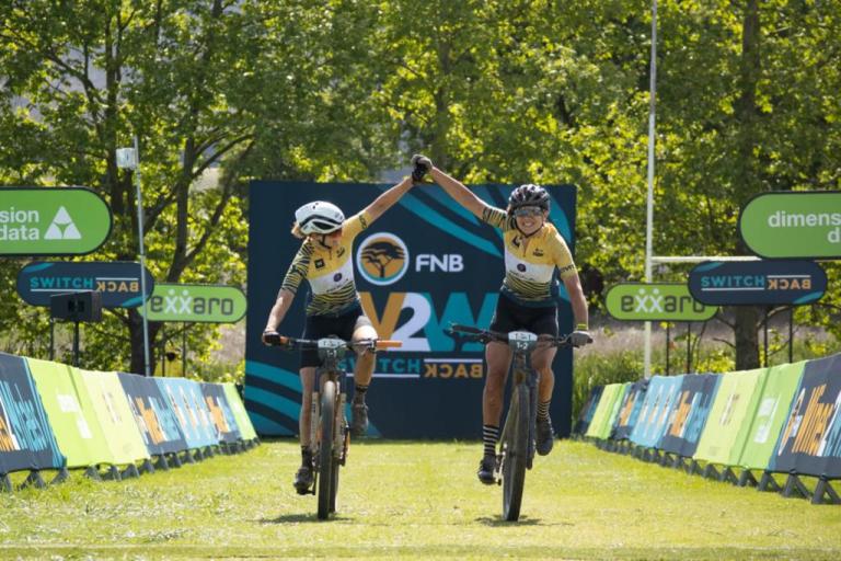 Two bikers holding hands near the W2W finish line