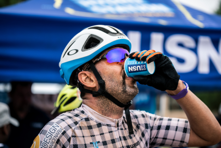 A biker drinking from a USN cup