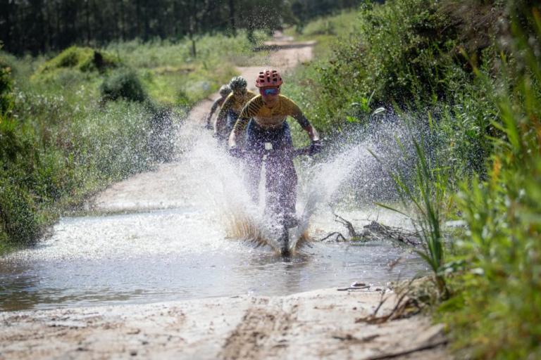 Adelheid Morath, from team Faces, splashes through one of the puddles left on the route after the previous day’s downpour. Image by Xavier Briel