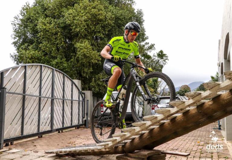 Biker heading up a homemade set of wooden stairs