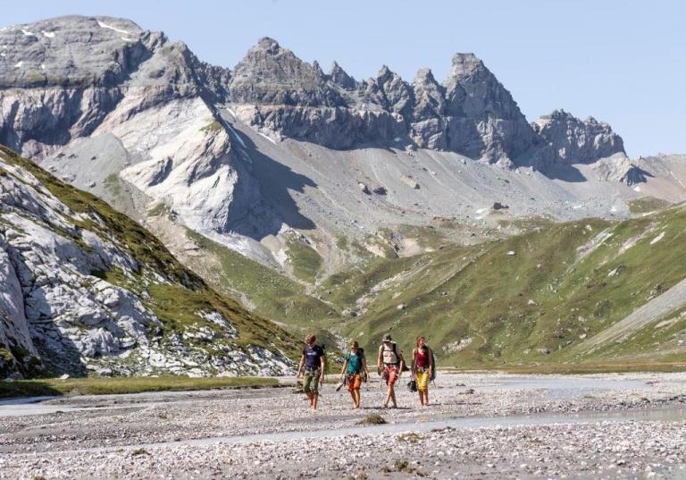 Four bikers walking in a valley