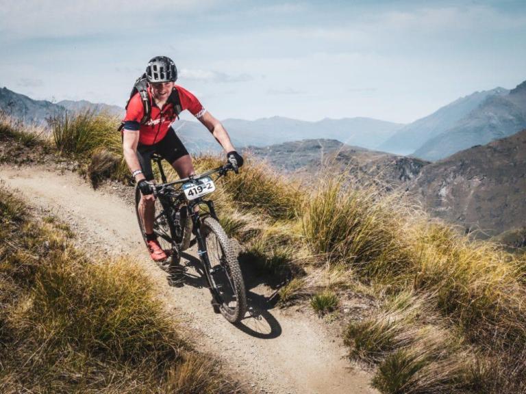 One biker traversing over the mountain