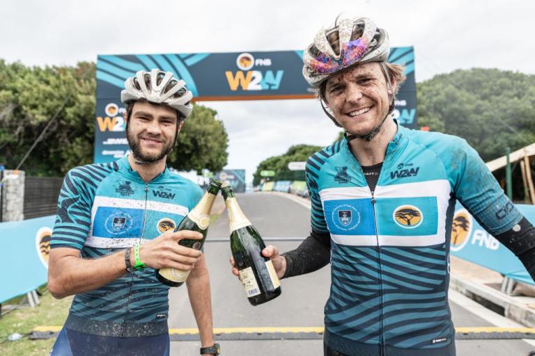 Varsity MTB men’s winners, Michael Lambrecht and Richard Simpson celebrate after three days of intense racing at the 2019 FNB Wine2Whales Pinotage 3 day mountain bike event stage3 from Oak Valley to Onrus. Image by Xavier Briel