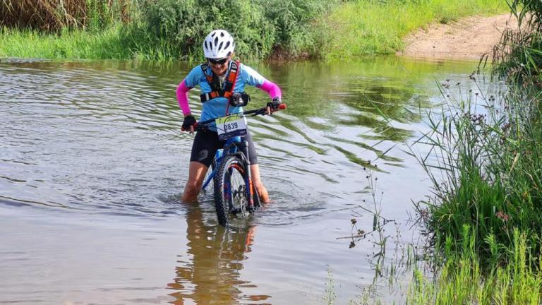 Rowen in the water with her bike