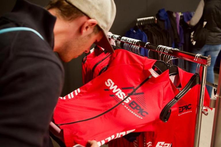 Close up of someone examining Swiss Epic merch