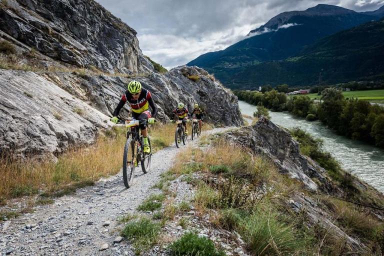 Three bikers heading along the Swiss mountainside