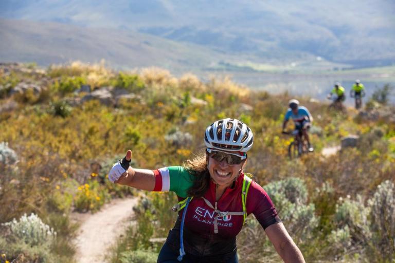 Rider smiles and gives thumbs up on FNB Wines2Whales trails