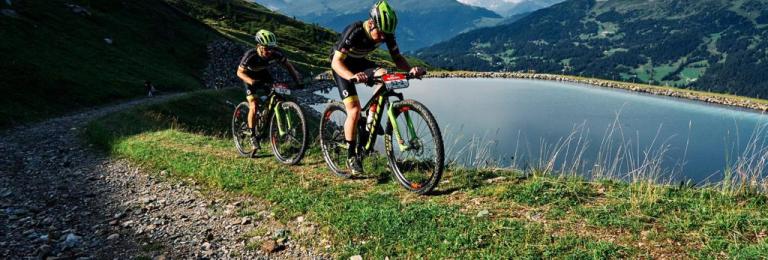 Bikers traveling near a lake path