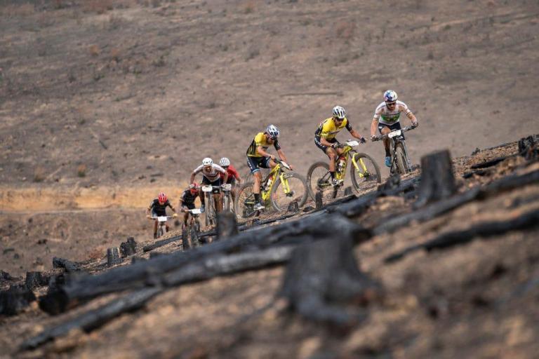 multiple bikers heading up an incline
