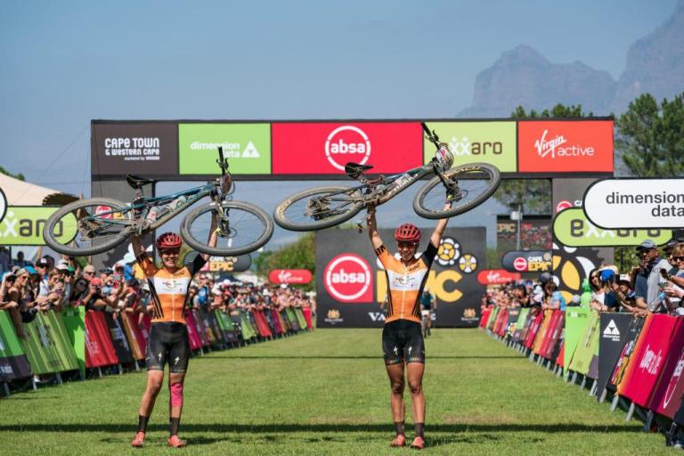 Breggen and partner holding bikes above head after epic series cape town race