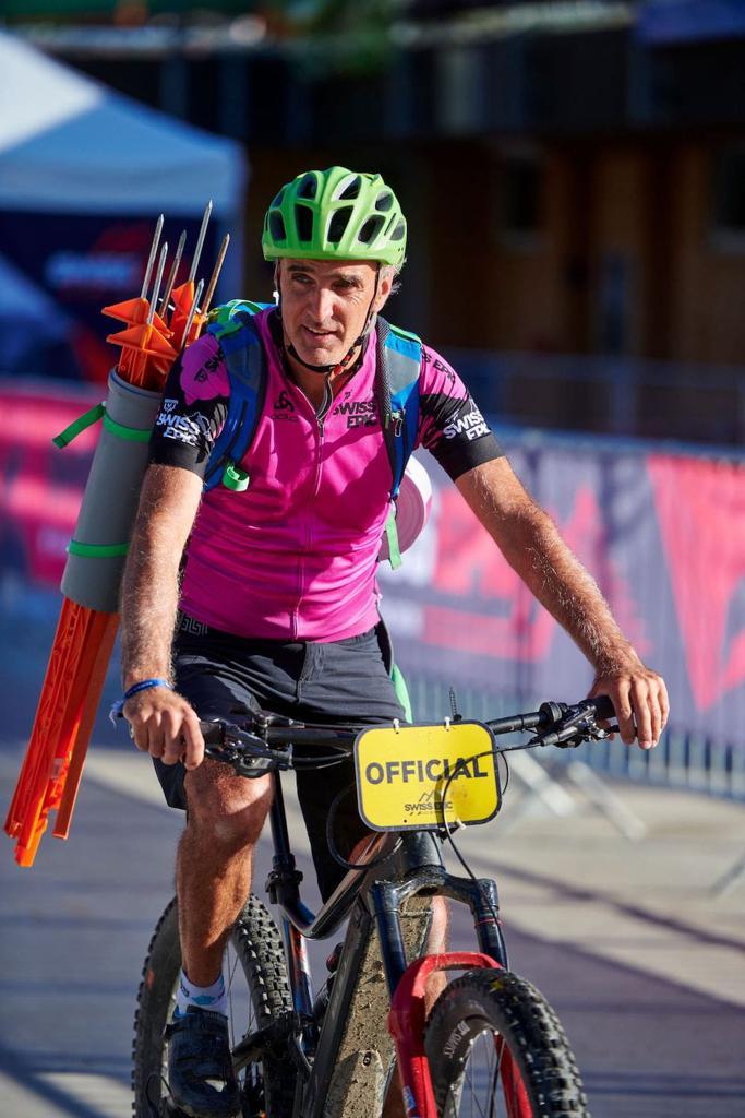 A member of the Swiss Epic route team with markers in his bag