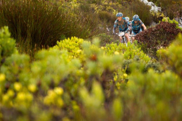 three bikers heading through the rough brush of the epic race