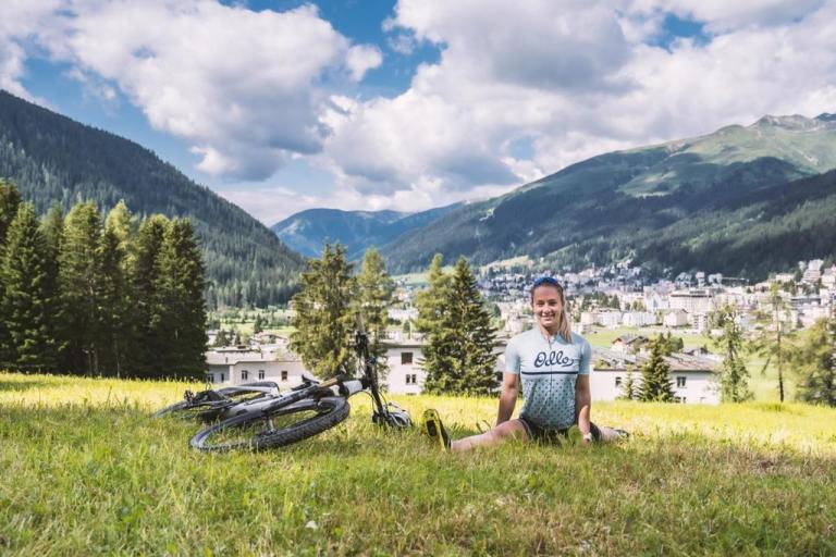 Ariella Kaeslin stretching by her bike