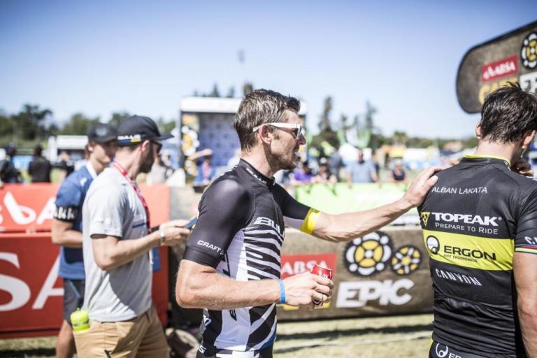 A biker putting a hand on Alban Lakata's shoulder