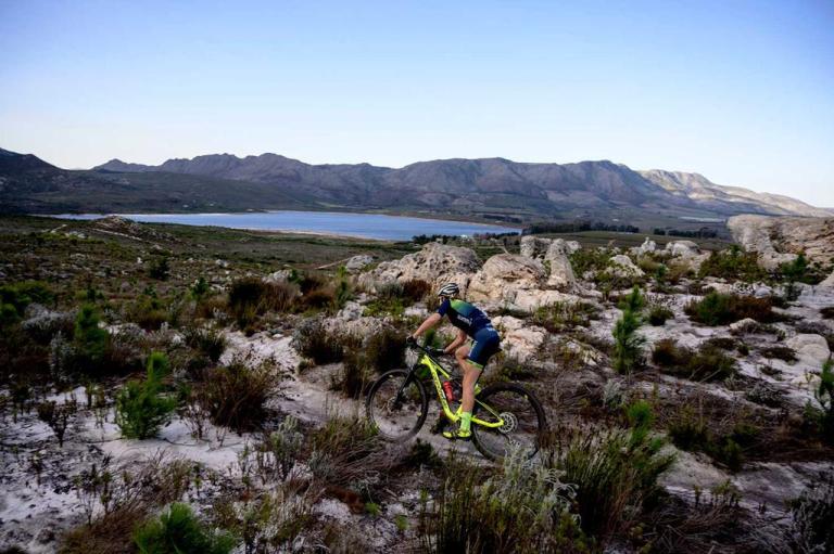 A singular biker on a rocky landscape