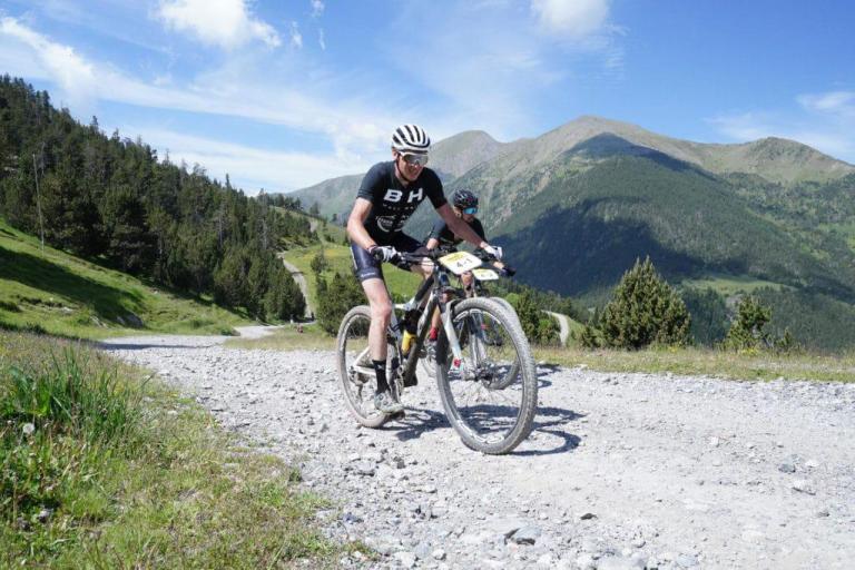 A rocky path with two bikers heading through the mountains