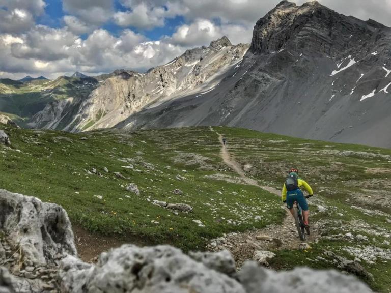 Stefan Wolfisberg biking through the Alps