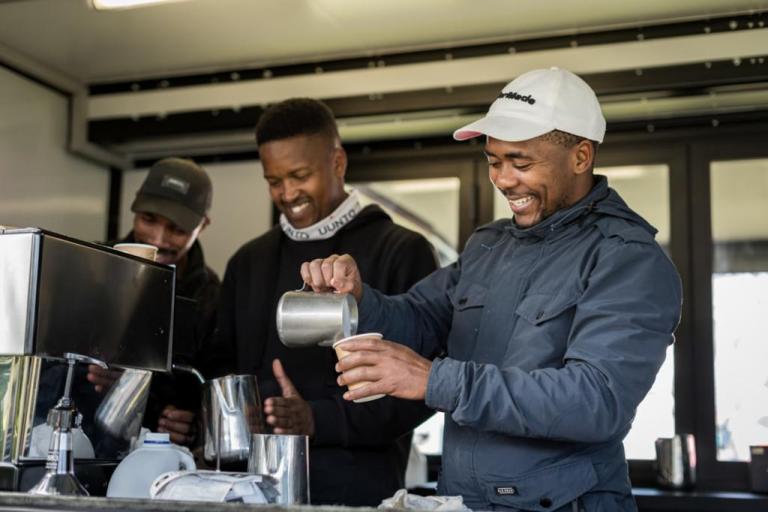 Three guys pouring coffee