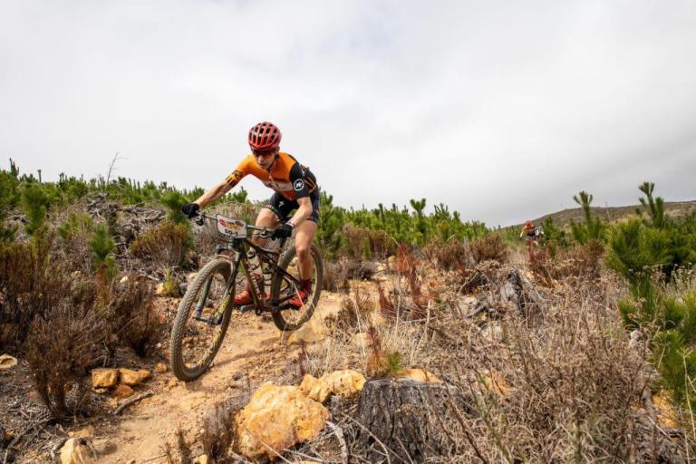 A biker (Langvad) heading across rocky terrain
