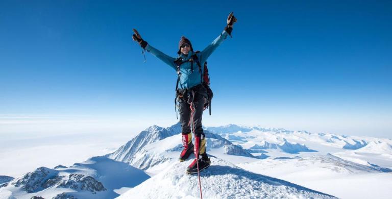 Wayne Morris posing ontop of a peak 