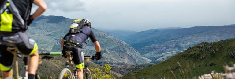 Two bikers heading over Mt Difficulty on The Pioneer