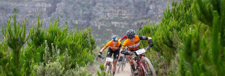 two bikers peddling through the mountains