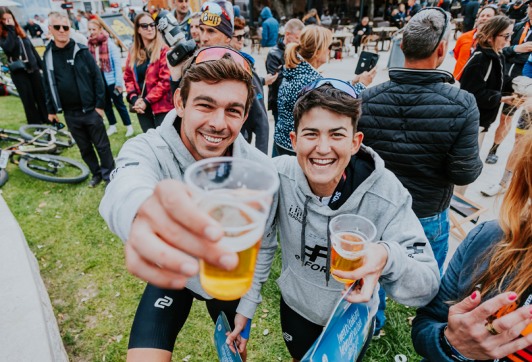 Two happy riders with their beers in the finish line 
