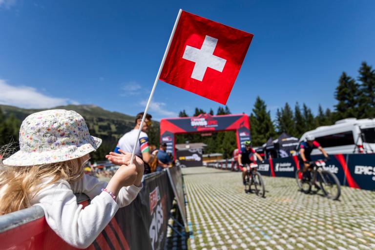Swiss Epic supporter at Finish Line with Swiss flag