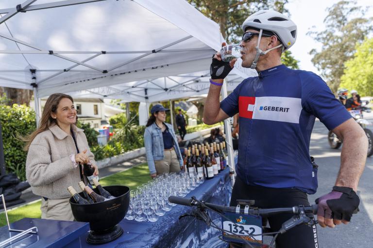 Blaauwklippen Wine Estate’s pop-up tasting room, at water point 2, proved a popular stop with less competitive riders (and the Open Category stage winners, Vera Looser and Sabine Spitz). Photo by Sam Clark. 