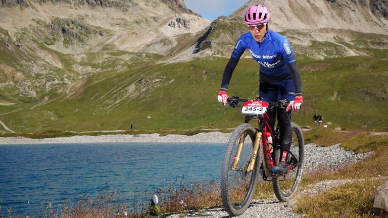 Two bikers taking a steep turn over a large drop [Swiss Epic]