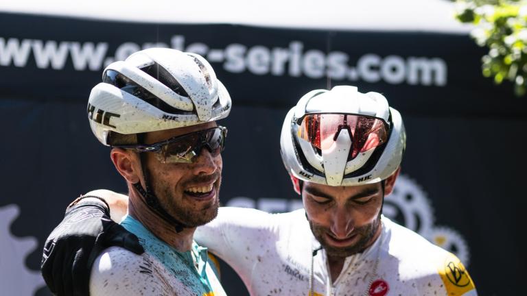 Two bikers in orange celebrating [Swiss Epic]