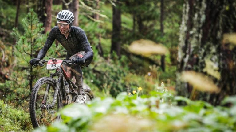Geismayer caked in mud biking through the Alps [Swiss Epic]