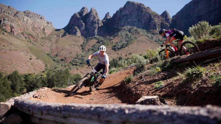a biker taking a steep dirt turn [FNB Wines2Whales]