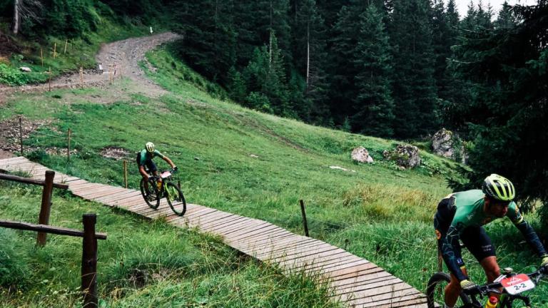 Two bikers heading across a bridge [Andorra MTB Classic-Pyrenees]