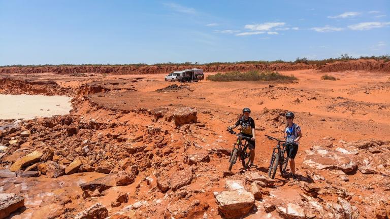 Lehmann and Anson-Smith posing on some dark red clay roads [Cape to Cape]