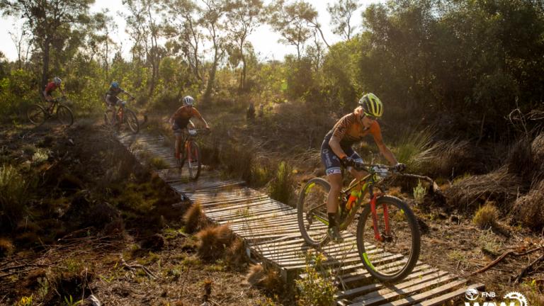 Groot and McDougall crossing a wooden bridge [FNB Wines2Whales]