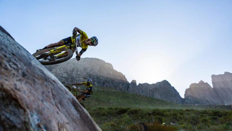 A biker basically biking horizontal on a mountain [Swiss Epic]