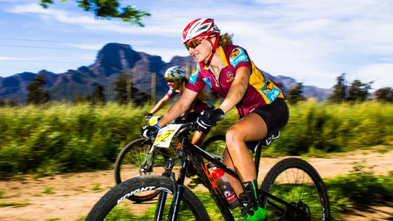 Two bikers racing against a mountain backdrop [FNB Wines2Whales]