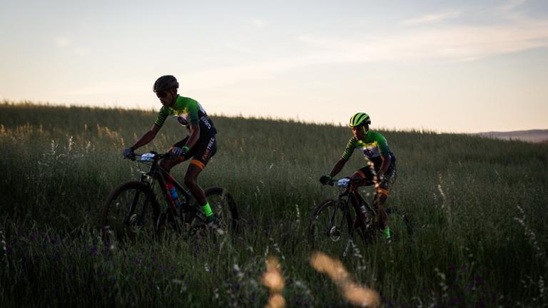 Two bikers heading through a field [FNB Wines2Whales]