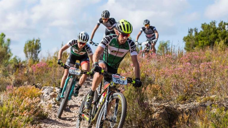 Scott-SRAM team heading down a meadow biking [Swiss Epic]