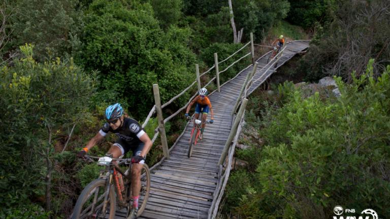 Bikers heading over a bridge made of wood [FNB Wines2Whales]